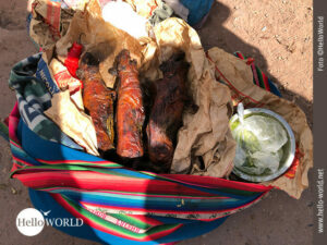 Das Bild aus Cusco, Peru, zeigt einen bunten Sack in dem drei gebratene Cuy liegen.