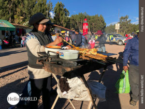 Sorgfältig geölt: Fleischspieße für den Verkauf Das Bild aus Cusco, Peru, zeigt eine Frau auf dem Sonnenfest, die einen kleinen Stand mit einem Grill aufgebaut hat und darauf Fleischspieße zubereitet.