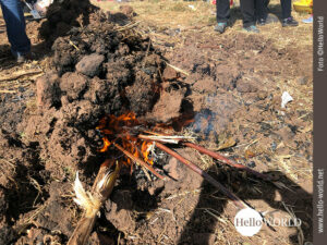 Das Bild aus Cusco, Peru, zeigt einen brennenden Erdh&uuml;gel, in dem Kartoffeln garen.